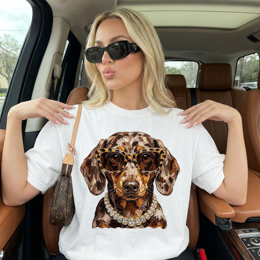 Glam dachshund with leopard glasses and jeweled collar on a white Comfort Colors tee