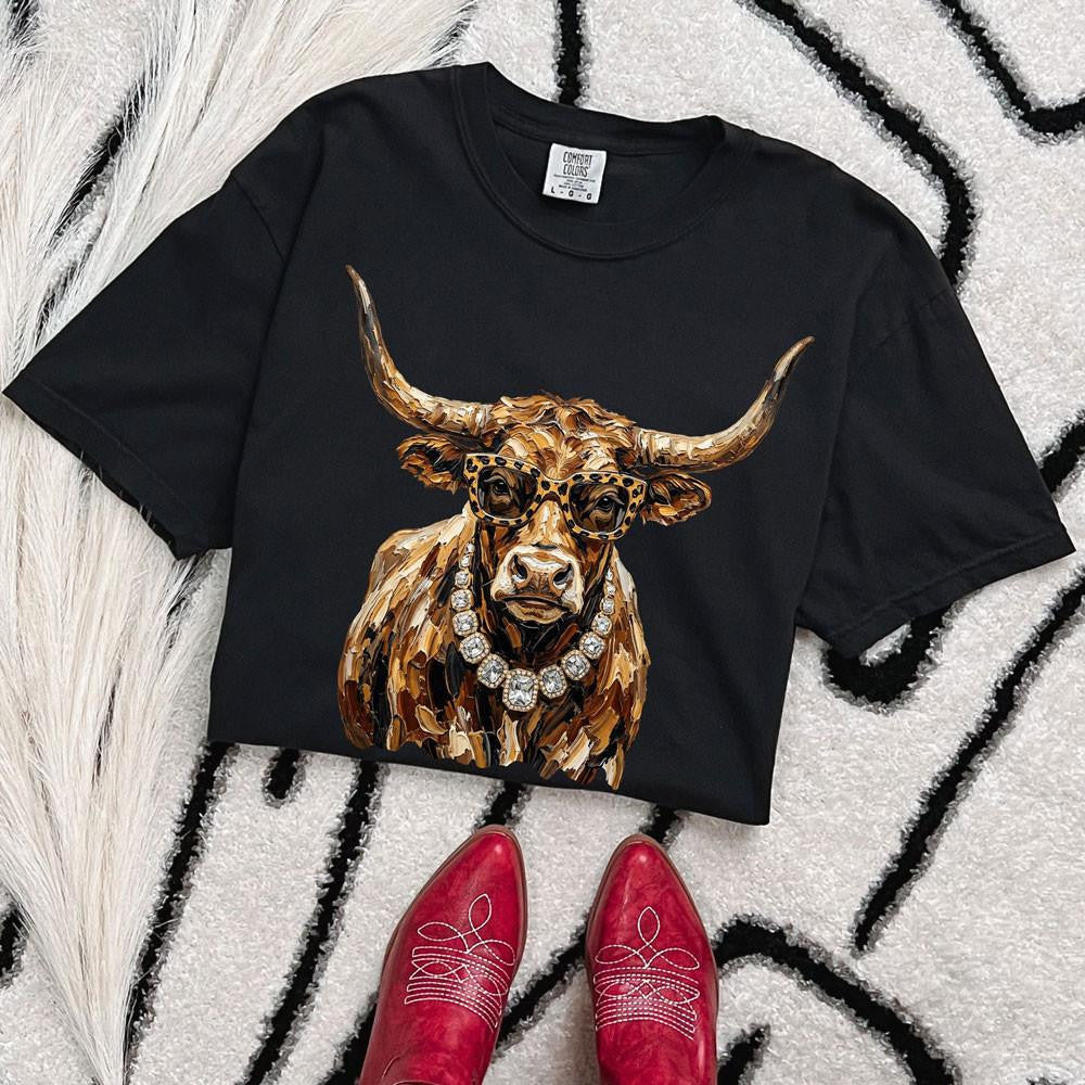Glam longhorn with leopard glasses and jeweled necklace on a black Comfort Colors tee