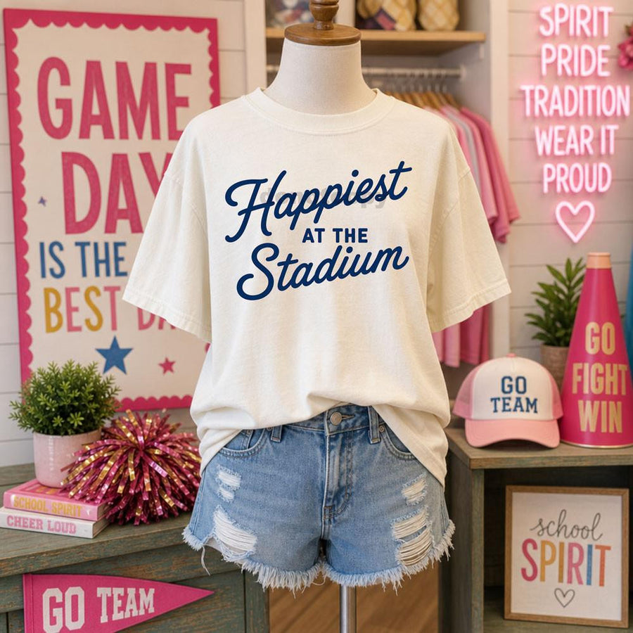 Happiest At The Stadium navy script graphic on an ivory Comfort Colors tee